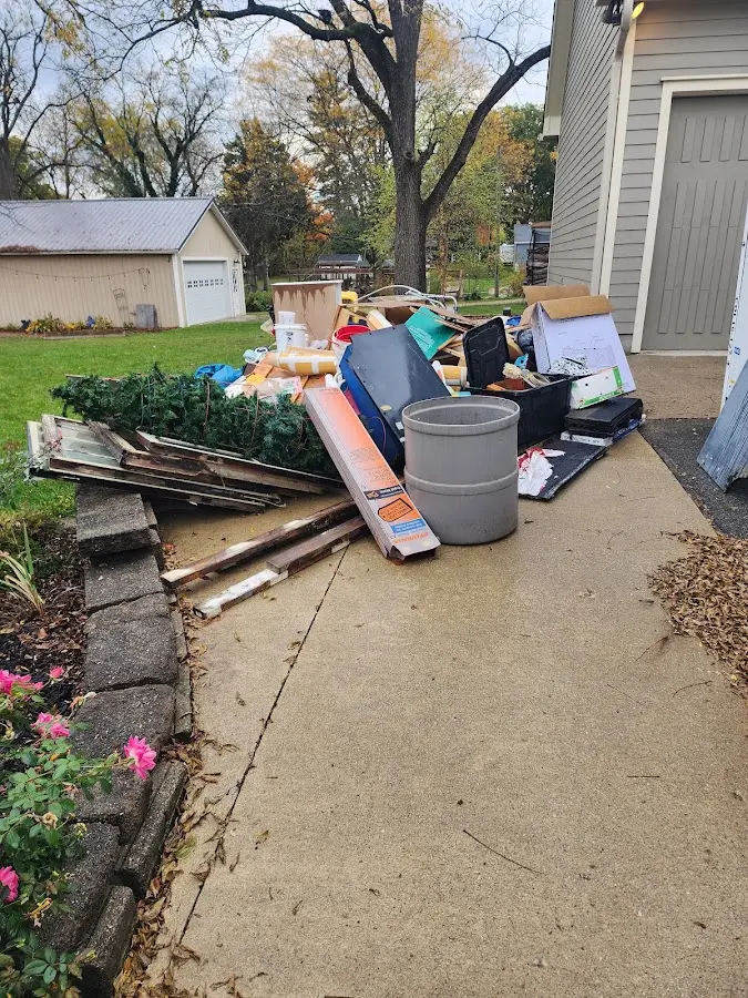Dumpster being loaded with debris for 12 Yard Dumpster Rental in St. John